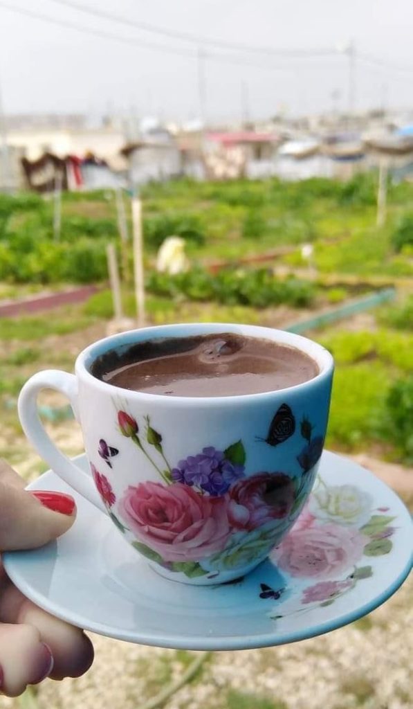 Floral teacup with coffee in the Azadi Community Garden, Domiz 1 camp, Kurdistan