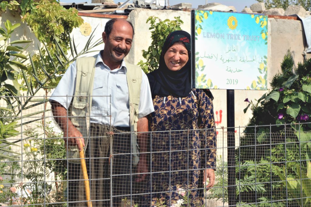 October 2019 Garden of the Month winners Muhammed Hssen and Zainab Abdullah standing in their home garden, Ashti neighbourhood, Domiz 1 camp, Kurdistan Region of Iraq